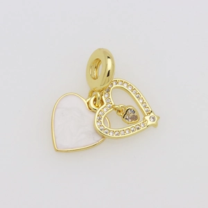 Close-up of pink enamel heart pendant with sparkling cubic zirconia on gold plating