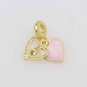 Detail of double heart pendant with pink enamel and gold hollow frame with crystals