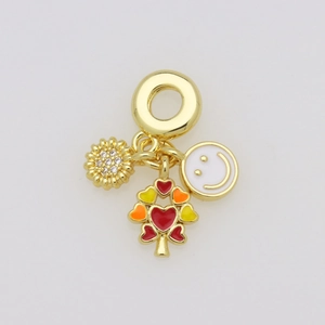 Macro shot of gold pendant featuring a sparkling sunflower, smiley face, and heart tree charms
