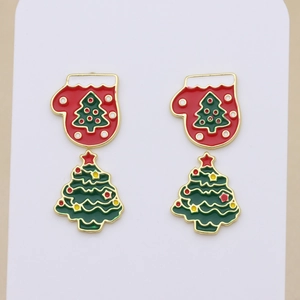 Detailed close-up of Christmas earrings with red mittens and green tree drop charms