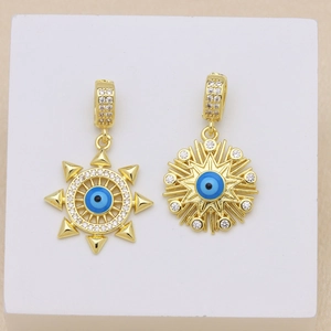 Detailed macro shot of 18K gold plated evil eye earrings with blue beads and zircon