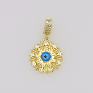 Macro shot of gold plated evil eye pendant with blue zircon and sparkling crystals
