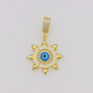 Macro shot of 18K gold plated evil eye pendant with blue crystals and sunburst spikes