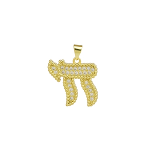 Macro shot of gold Chai pendant with white cubic zirconia and beaded texture