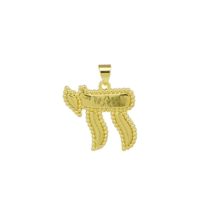 Macro detail of golden Chai pendant featuring a beaded edge and polished metal finish