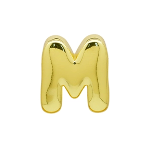 Macro shot of polished gold-plated letter M pendant with reflective mirror finish