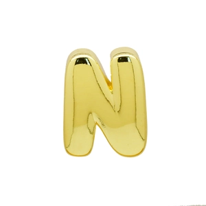 Macro shot of 3D balloon style golden letter N pendant with a polished mirror finish