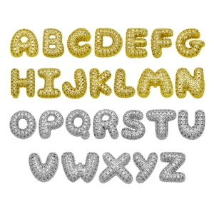 Icy bubble letter pendants set with pavé cubic zirconia in gold and silver plating