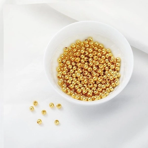 Close-up of polished 14K gold plated round loose beads for DIY jewelry making