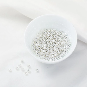 Detailed view of textured silver round beads with fine spherical facets for jewelry making