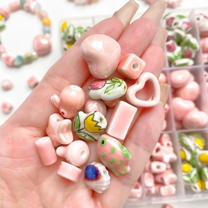 Handmade pink sakura ceramic beads set for DIY jewelry making featuring floral designs