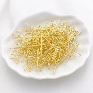 Premium 14K gold plated head pins for DIY jewelry making displayed in a shell tray