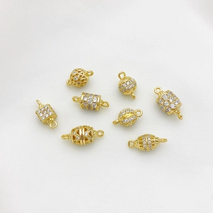 14K gold-plated double-loop connectors with micro-pave cubic zirconia on white linen