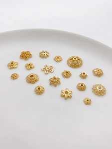 Macro view of assorted 14K gold plated flower bead caps and spacers for DIY jewelry making