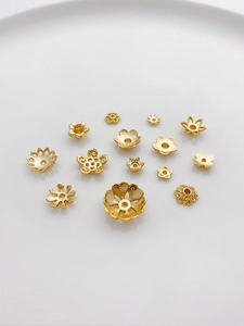Macro shot of assorted 14K gold plated flower bead caps and spacers for DIY jewelry making