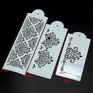 Three-piece set of white flexible plastic cake stencils with elegant scroll patterns