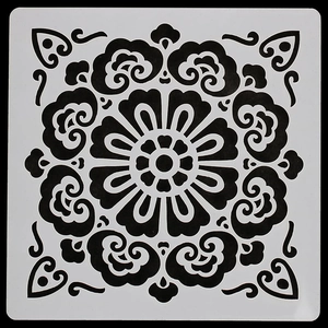 Détail d'un pochoir mandala carré blanc pour peinture DIY sur fond noir épuré