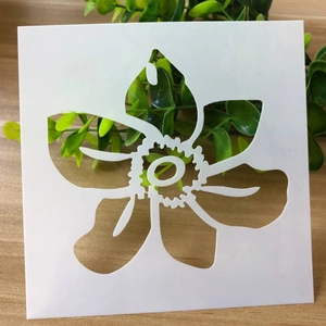 White square flower stencil with floral pattern on a natural light wood background