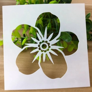 Close-up of a square white plastic flower stencil for DIY painting and drawing projects