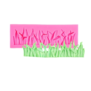 Pink silicone grass mold for fondant and chocolate cake decoration on white background