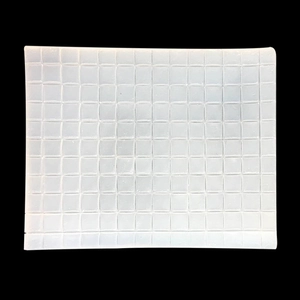 Macro detail of white silicone mat with uniform square grid texture for clay and fondant