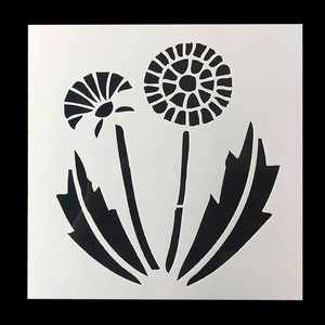 Detail showing a white plastic dandelion stencil with intricate hollow floral cutouts