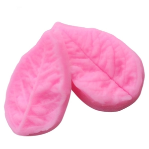 Detail of pink silicone leaf mold showing realistic vein textures for fondant cake decorating