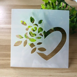 Macro detail of a square white translucent floral and heart stencil for DIY cake decorating