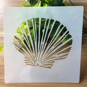 Reusable white PET square stencil with a detailed seashell cutout for DIY crafts and baking