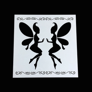 DIY scrapbook stencil featuring symmetrical fairy silhouettes and ornate scroll patterns