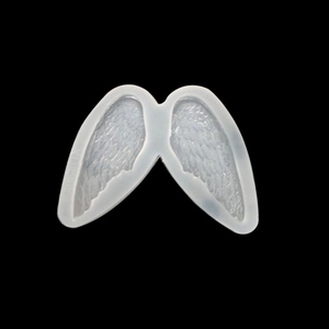 Macro detail of translucent angel wing silicone mold with intricate feather texture design