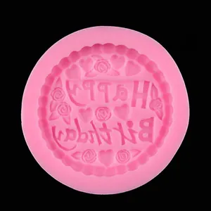 Macro shot of pink silicone mold with Happy Birthday text and floral relief patterns
