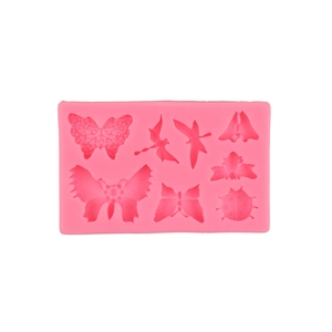 Pink silicone mold featuring dragonfly and butterfly insect shapes for DIY fondant or soap