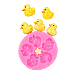 Detail view of pink silicone mold featuring mini ducks and flower for fondant decoration