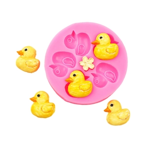 Detail of pink silicone mold with mini ducks and flowers for cake fondant decorating
