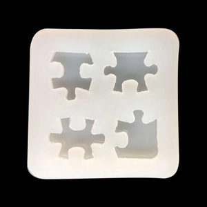 Top view of four jigsaw puzzle shaped silicone molds for DIY resin jewelry pendants