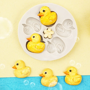 Mini duck and flower silicone cake mold for DIY fondant chocolate making on a beach background