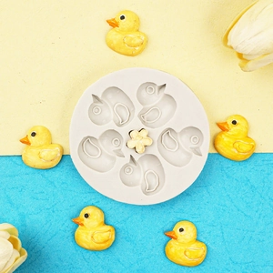 Detail of round grey silicone mold with duck and flower shaped cavities for baking