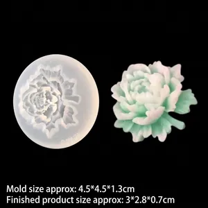 UV resin flower silicone mold with finished green gradient peony pendant on black background
