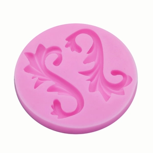 Pink silicone mold featuring symmetrical Baroque scroll patterns for cake decorating