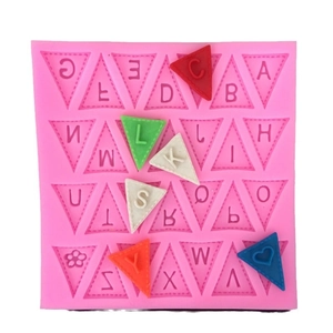 Pink silicone alphabet mold with triangular slots and colorful letter fondant pieces