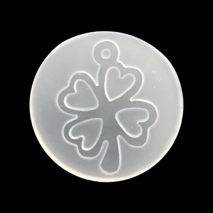 Close-up of translucent heart-shaped clover silicone mold for DIY resin jewelry making
