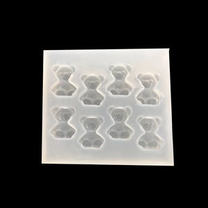 Semi-transparent silicone mold featuring eight bear shapes for DIY resin pendant crafting