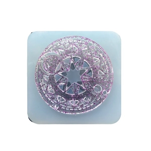 Star-shaped magical circle resin mold with purple glitter insert on light blue base