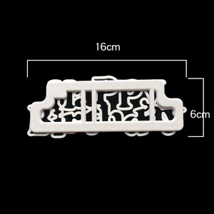 Detailed view of white 16x6cm plastic cake stencil with intricate hollow floral patterns