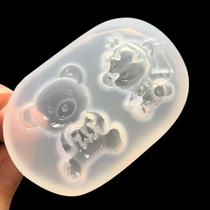 Handheld view of dual-cavity cartoon bear silicone mold for resin DIY pendant making