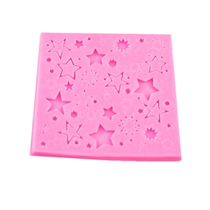 Pink silicone star mold for fondant and chocolate cake decorations on white background