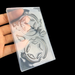 Translucent silicone mold for DIY resin pendants featuring wing and pentagram star designs
