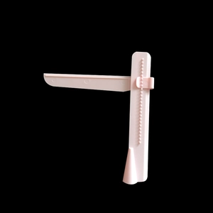 Adjustable pink fondant cake scraper tool for smoothing cream surfaces on tall cakes