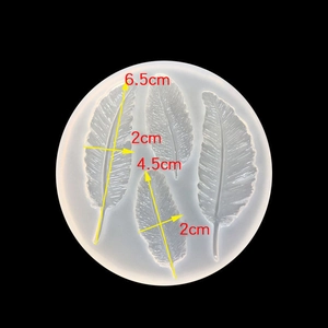 Macro shot of feather-shaped silicone mold showing detailed dimensions for DIY resin casting